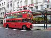 A classic London sight, a double decker bus and umbrellas