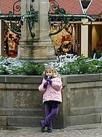 Playing a wooden slide whistle while Mom and Alex shop
